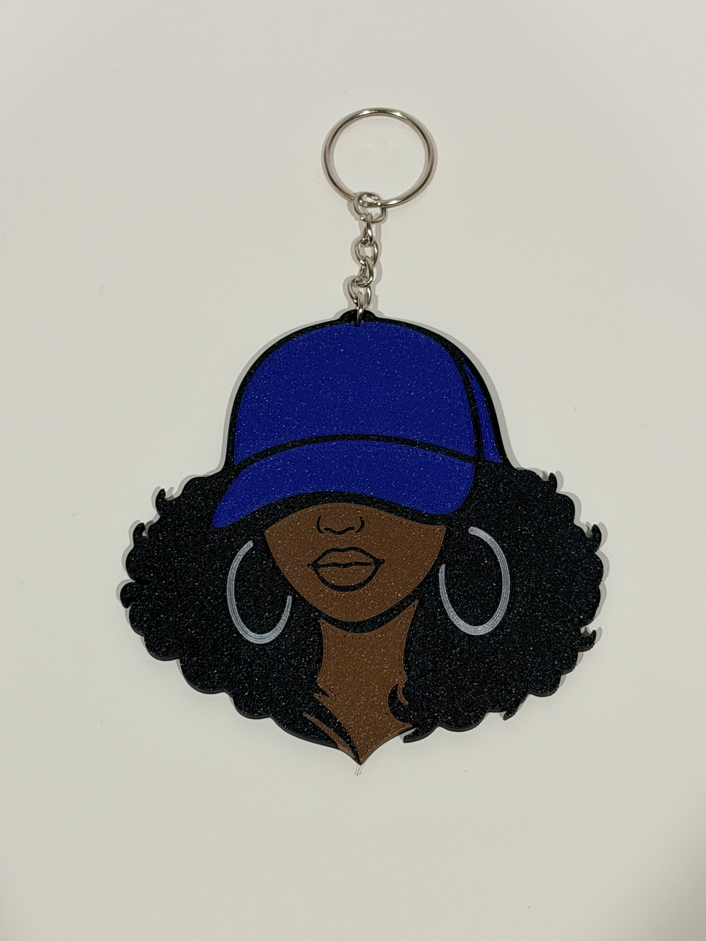 Curly Black Girl 3D Bag Charm with royal blue cap, voluminous curly hair and silver hoop earrings