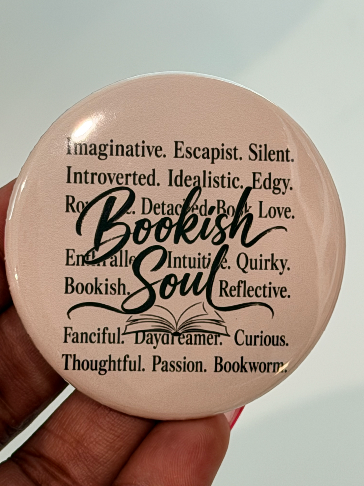 Bookish Soul 2.25 inch pinback button in blush pink with bookish personality words