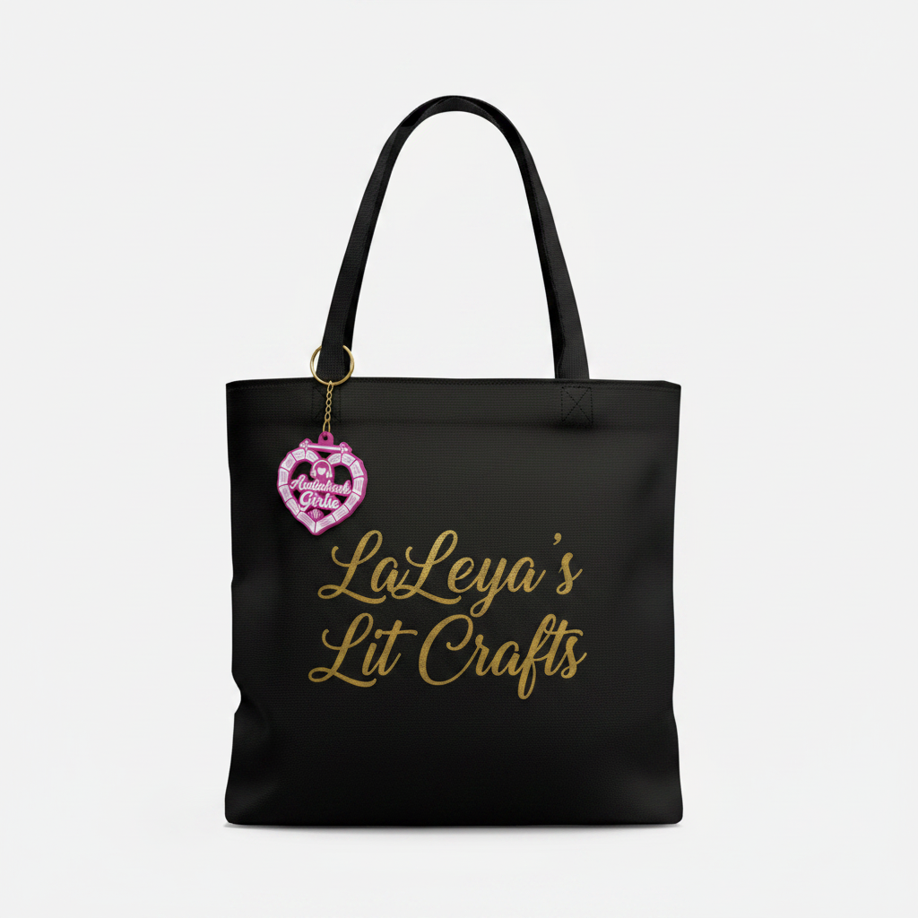 Audiobook Girlie pink keychain attached to a LaKeya's Lit Crafts tote bag