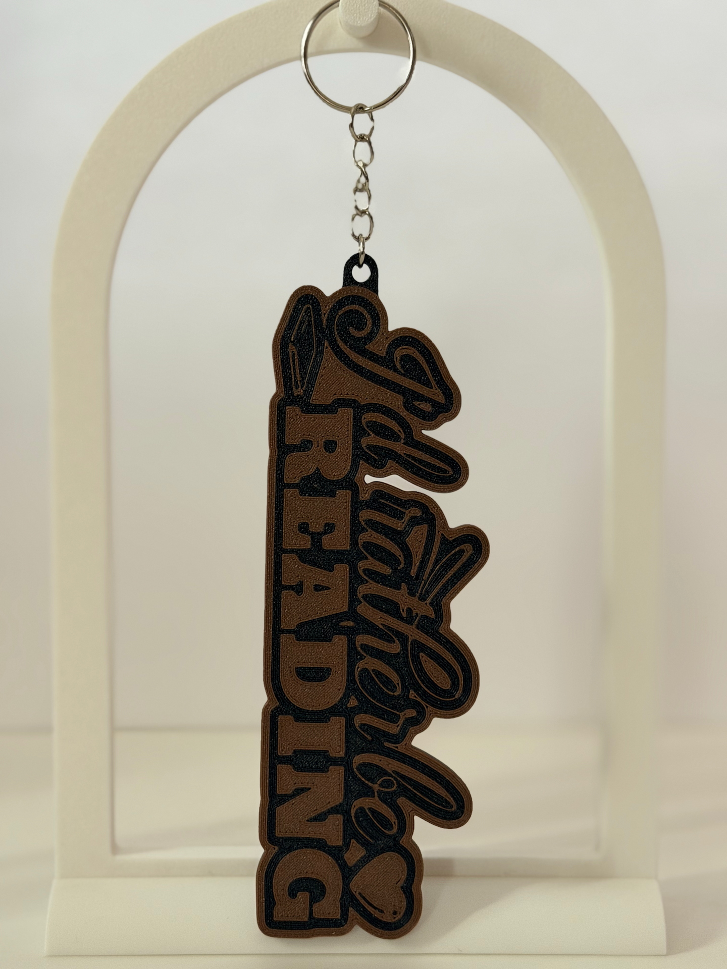 I'd Rather Be Reading 3D bag charm in cocoa-brown and black flat lay
